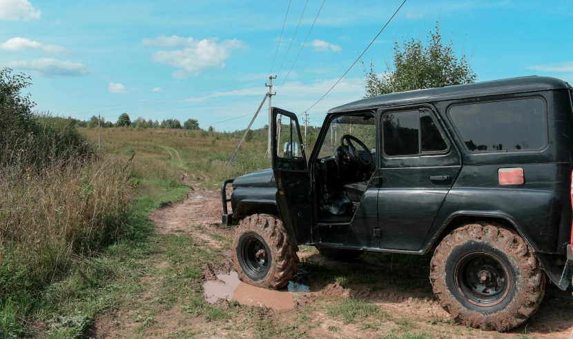 a jeep that is sitting on a dirt road