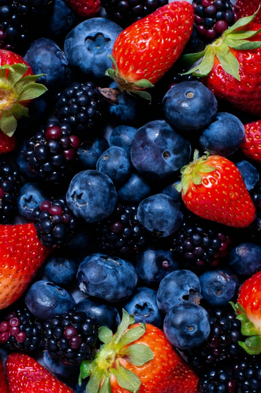 an overhead image of berries, blueberries, raspberries and strawberries