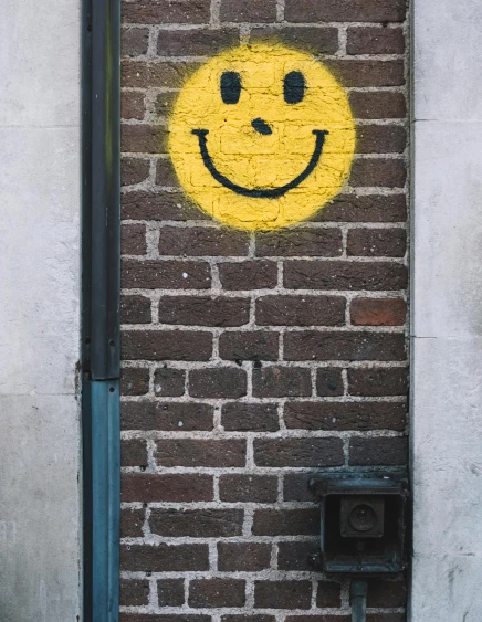 a smile painted on the side of a brick building