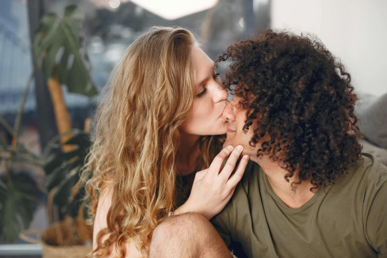 two people on the couch are kissing each other