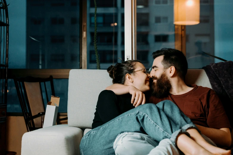 a man and woman are sitting together on a couch