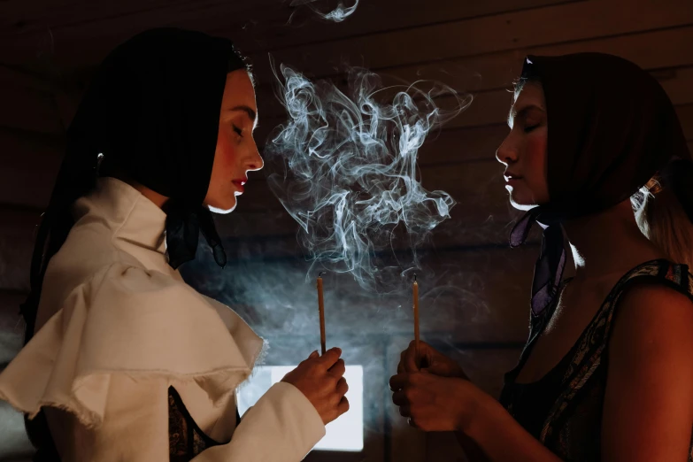 two woman smoking and talking each other