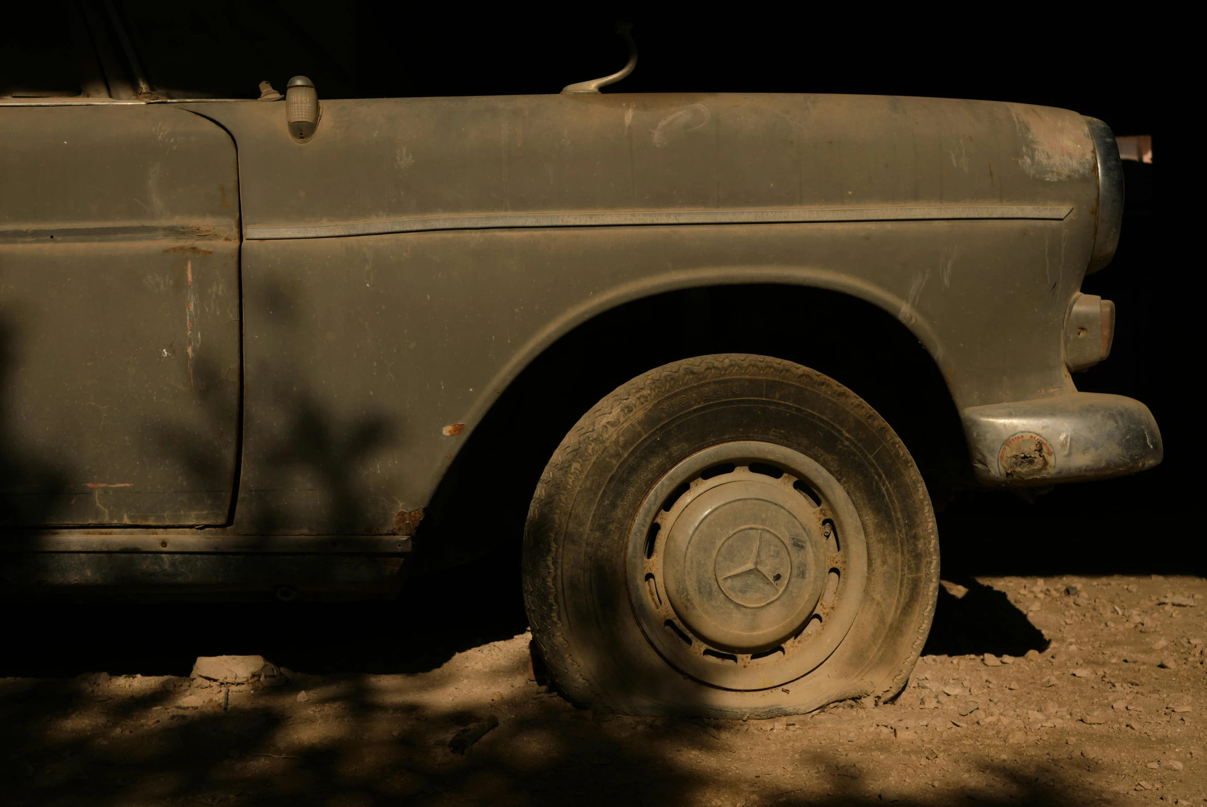 an old, dusty looking truck in the shade