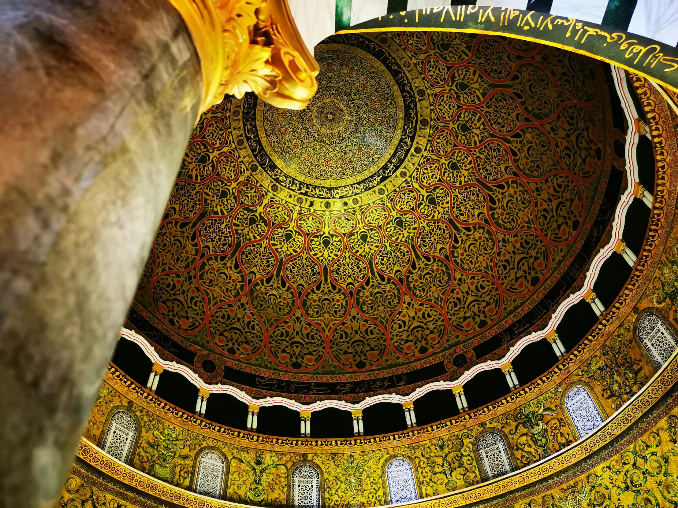 inside looking up at an ornate dome of a church