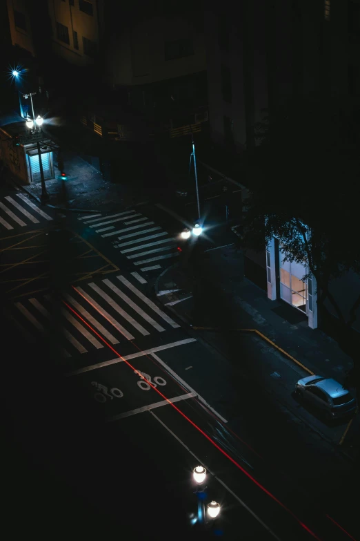 an intersection in the middle of an urban at night