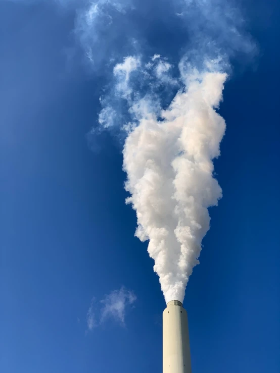 a smoke stack emitting from the sky