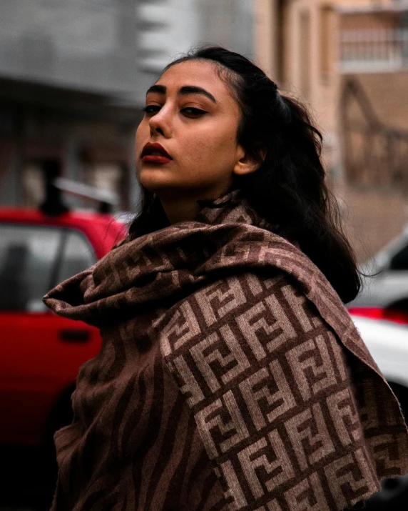 a woman in a towel stands near a street