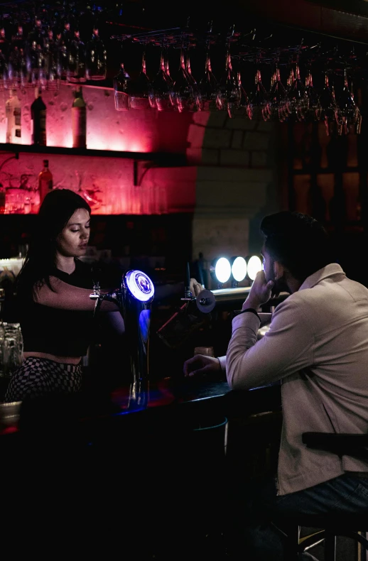 a man working at the bar with a woman in the background