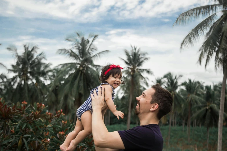 a man is holding a child and smiling