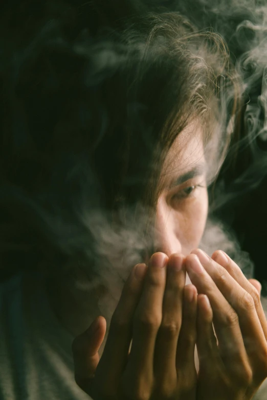 a young woman is taking a moment while smoking