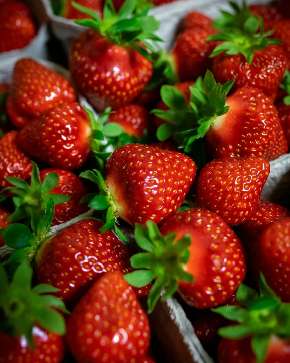 there is a very large pile of strawberries