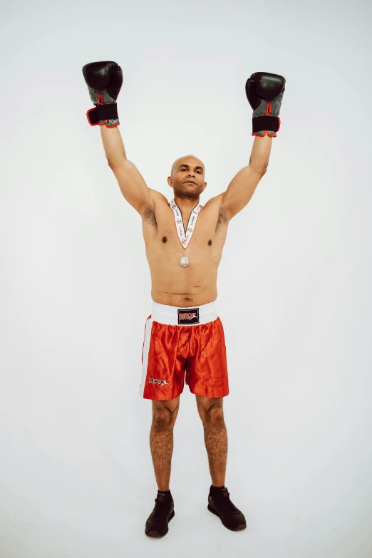 a man in a boxer shorts is holding two boxing gloves