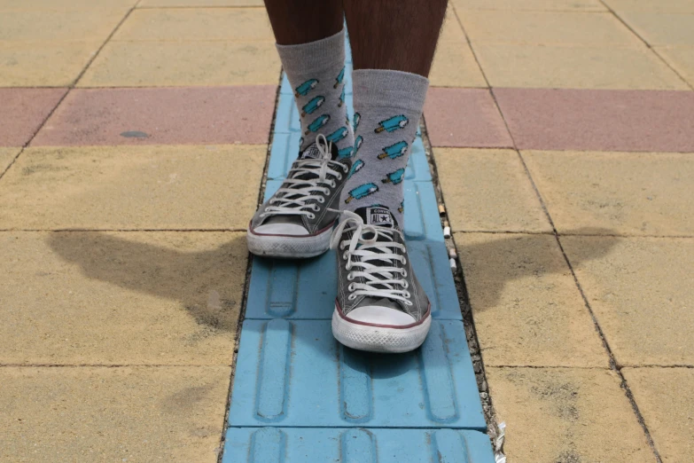 a person riding a skateboard down a sidewalk