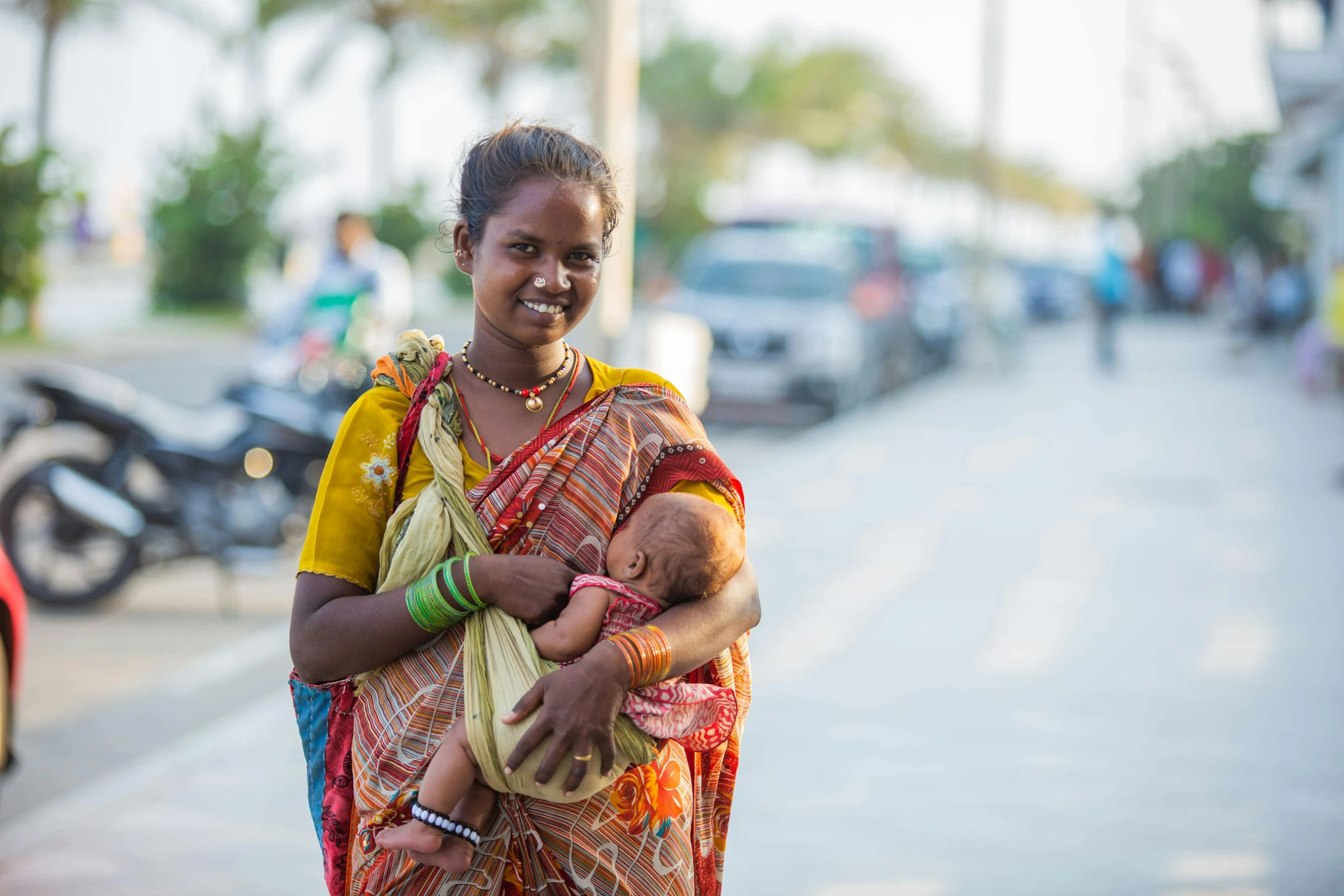 a lady carrying a baby in her arms