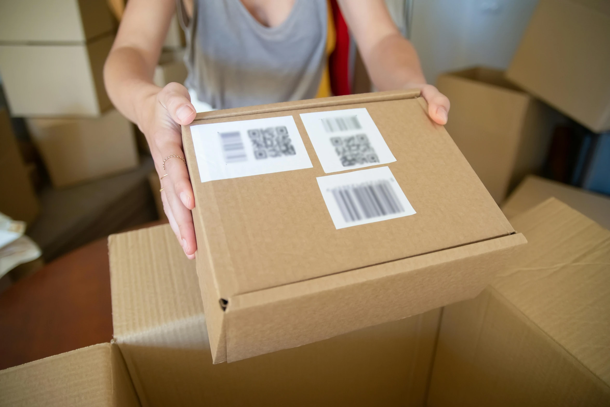 a woman holds a box with two stamps on it