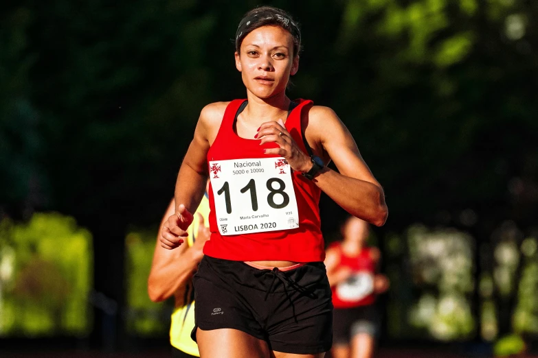 woman running a race wearing a red shirt