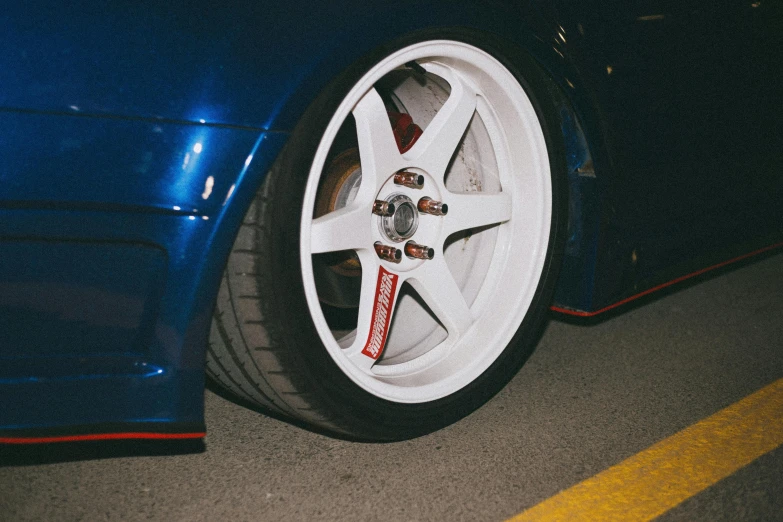 a blue sports car with red line painted on it's side