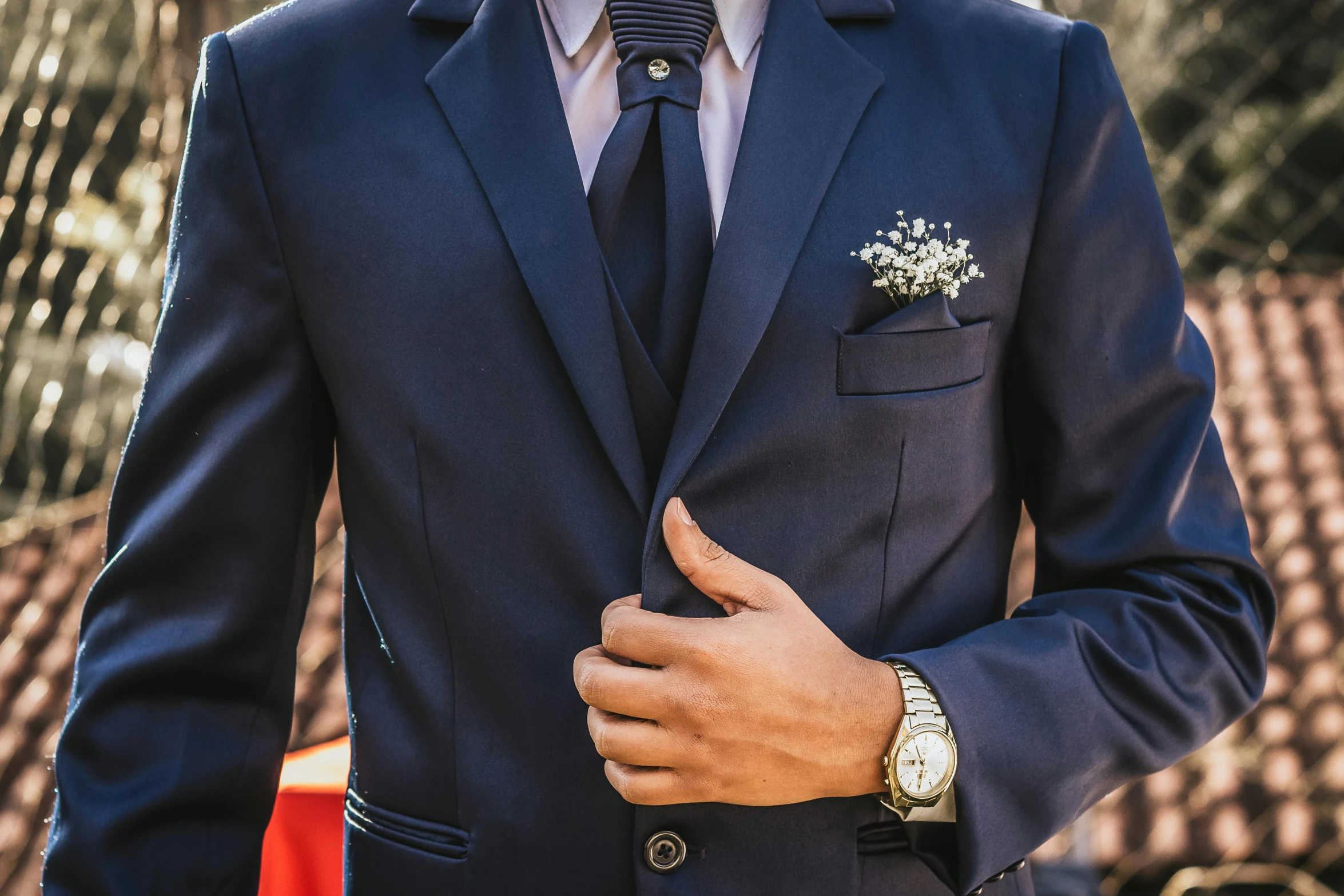 a close up of a person wearing a blue suit and tie