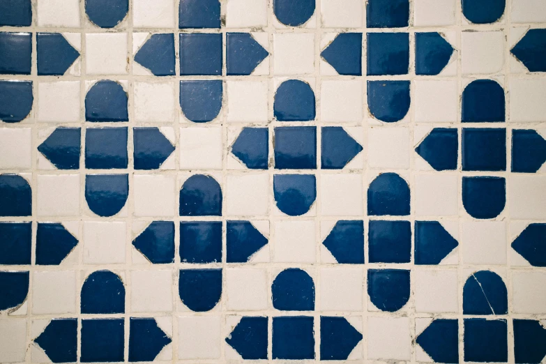 some blue and white geometric designs that are on a wall