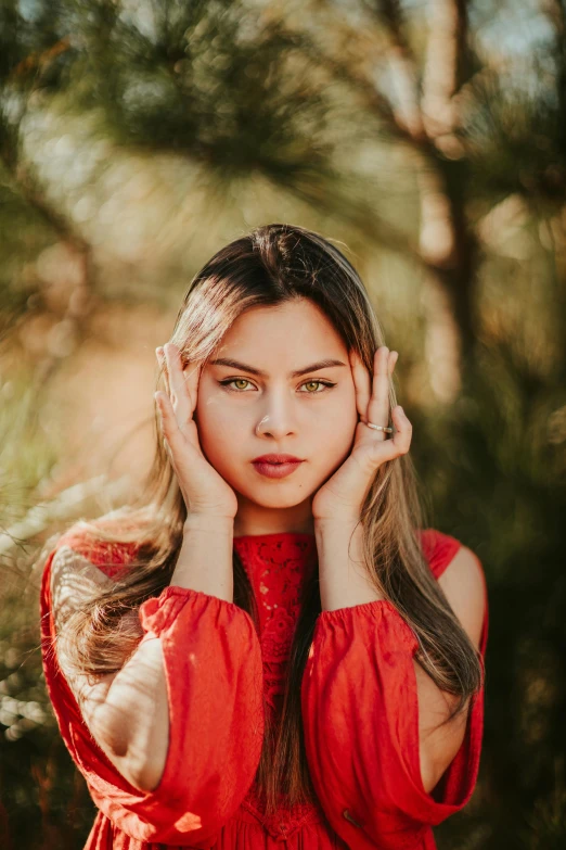 a young woman is posing in the forest