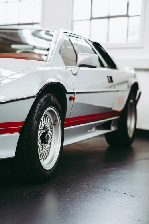 a very sleek and old looking silver car