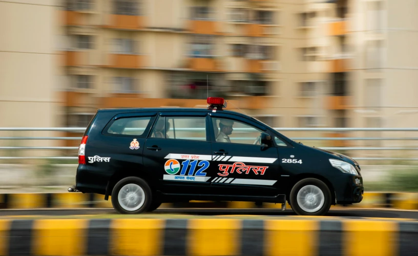 a taxi driving down the road with a sign on top