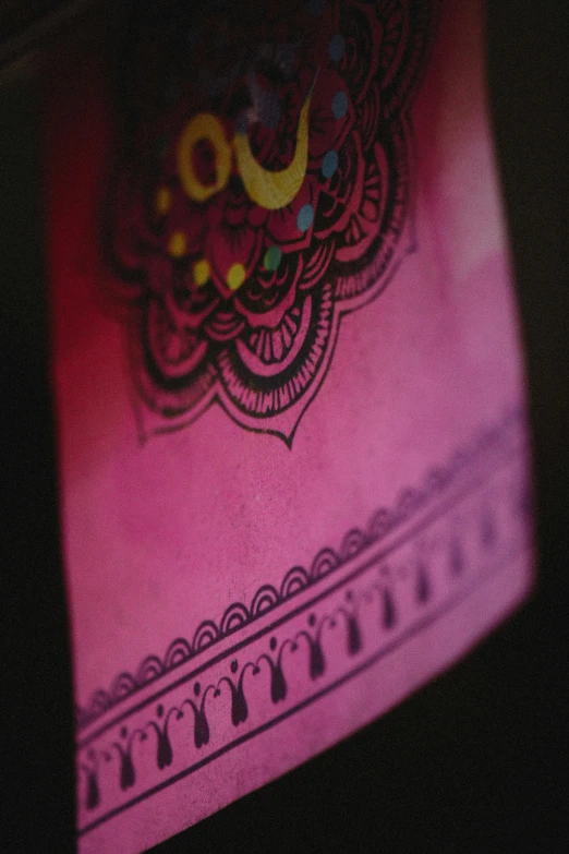 a decorated item on top of a pink lit up surface