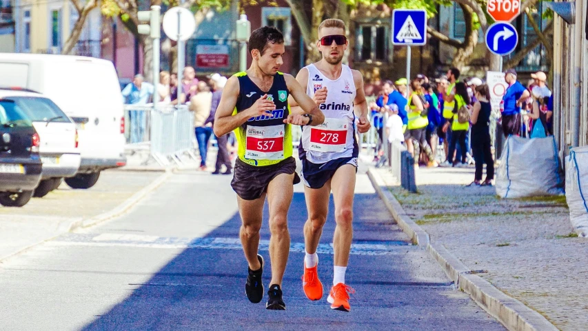 a marathon race, the man is running with his friend