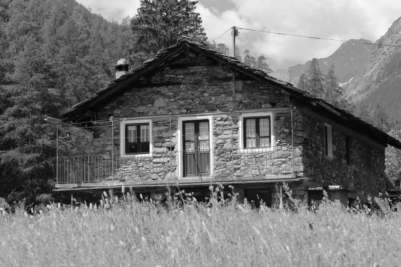 an old building in a field with a sky background