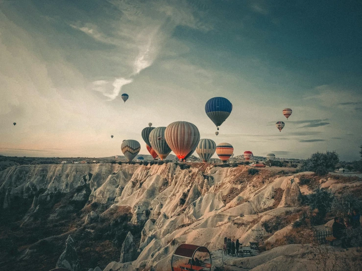 a landscape scene with a bunch of  air balloons