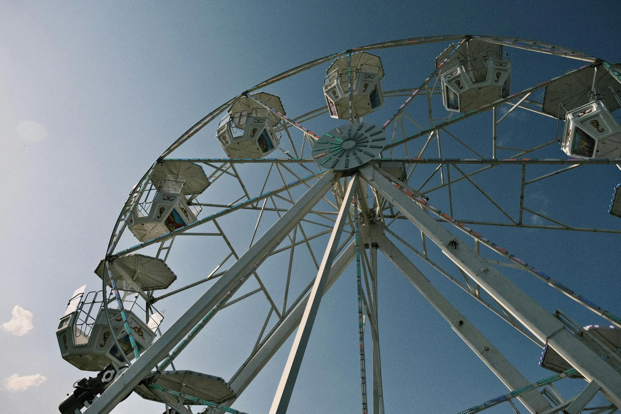 a ferris wheel under a cloudy blue sky