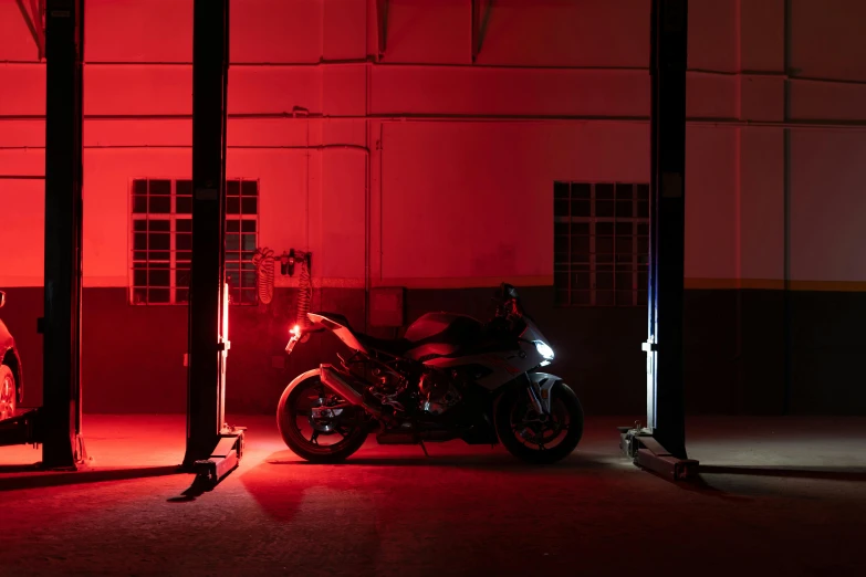 motorcycle parked outside of a large building in dark