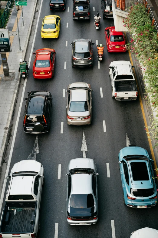 a busy city street with cars parked along it