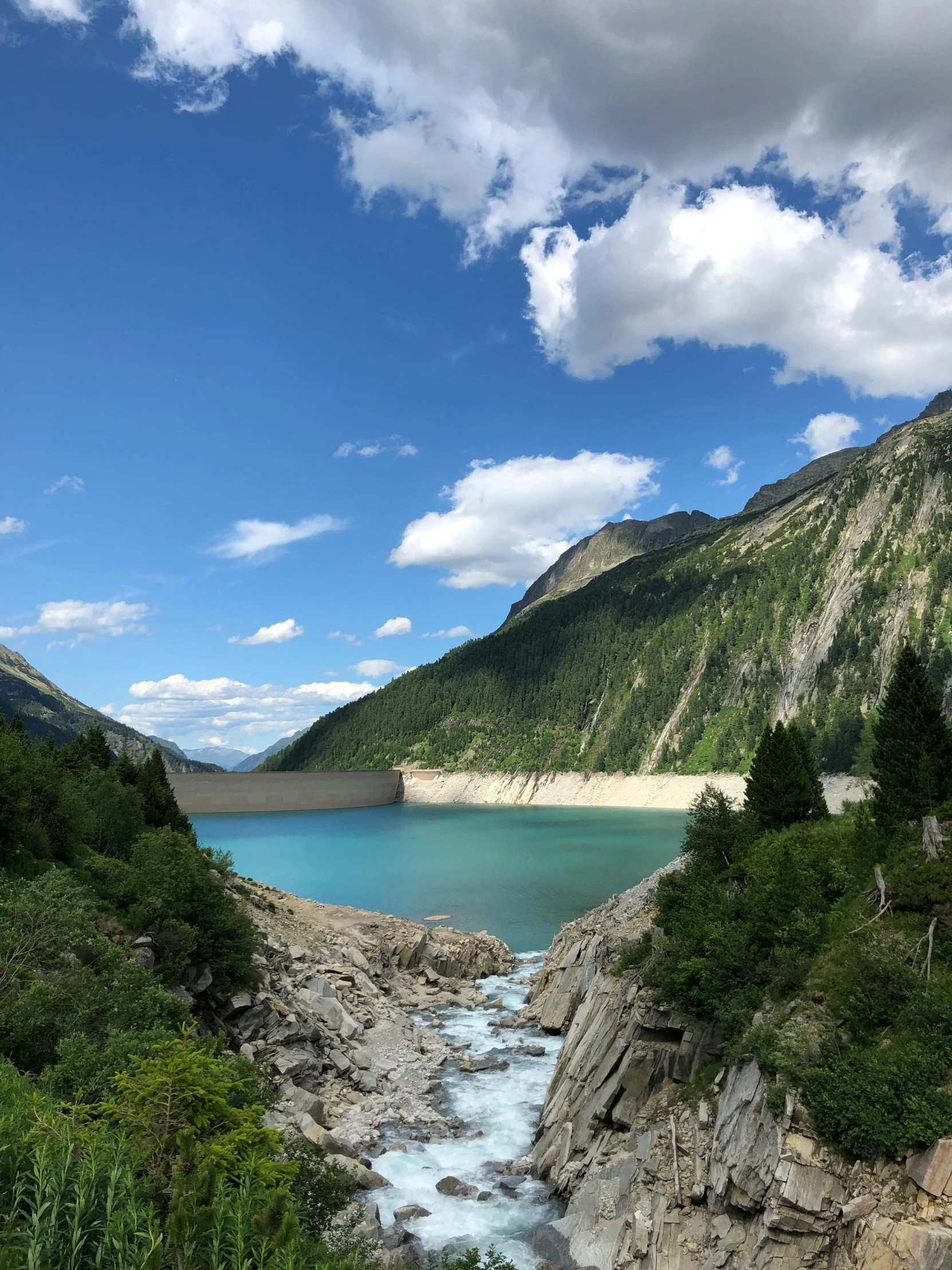 a large body of water sitting below some mountains