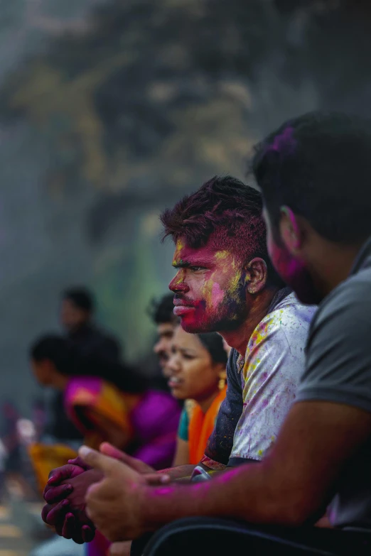 many men with faces painted in bright colors