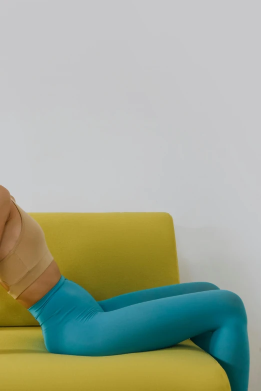 a woman with a very large fake hand on a couch