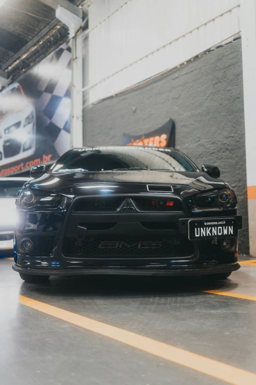 a car in a garage with its hood partially hidden