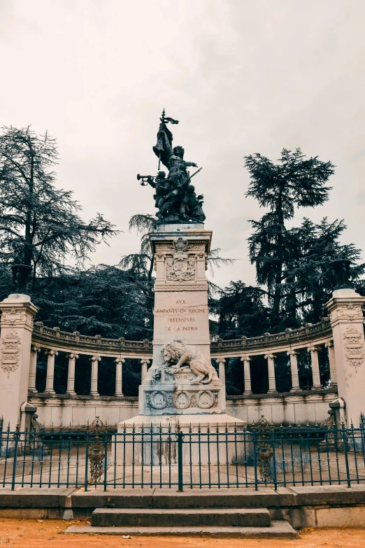 the statue is in front of a fenced area