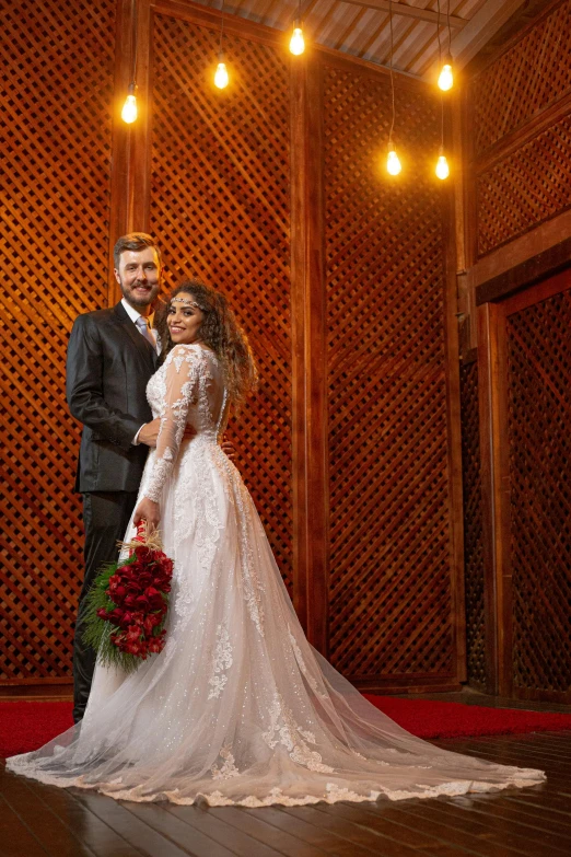a man and woman in wedding outfits posing for a picture