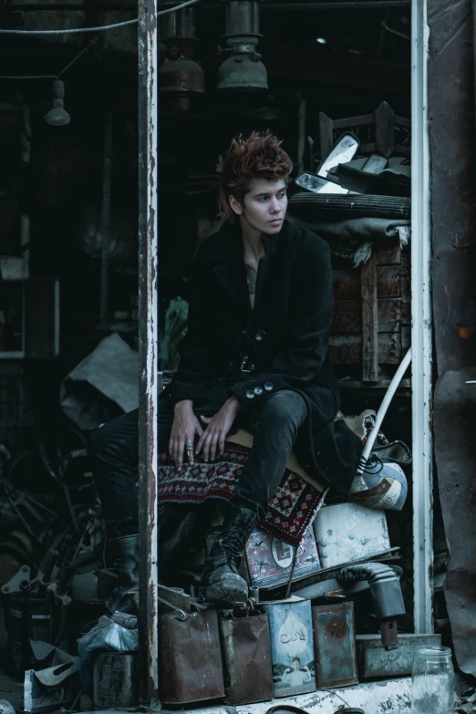 a young man sitting on top of an old building