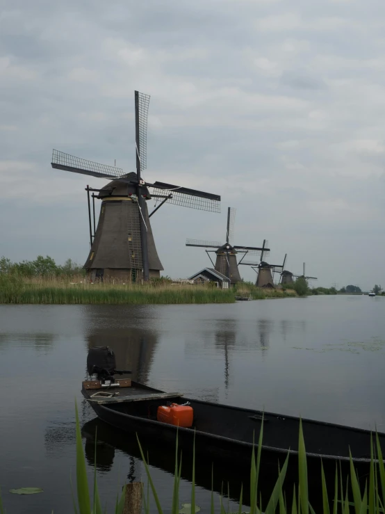 the boat is at rest along side the windmills