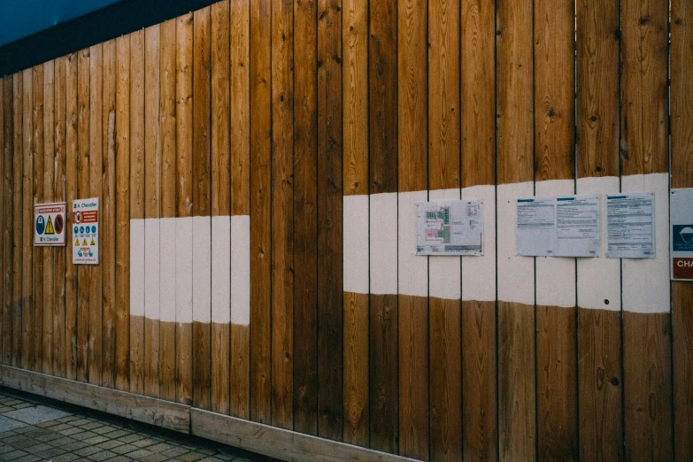 a wooden building with several signs displayed on the outside