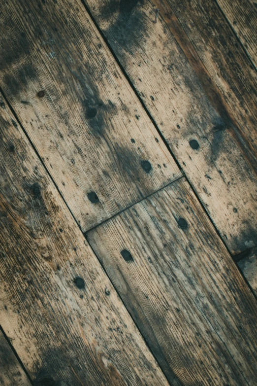 an old wooden plank with a clock on it