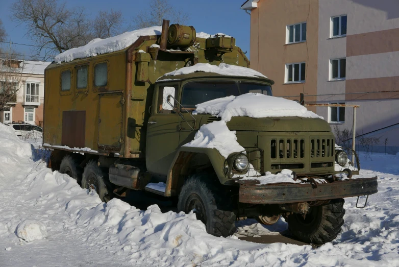 a military vehicle is driving through the snow