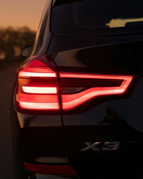 the rear lights of a black vehicle