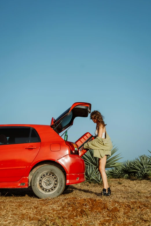 a lady getting ready to load her car in the desert