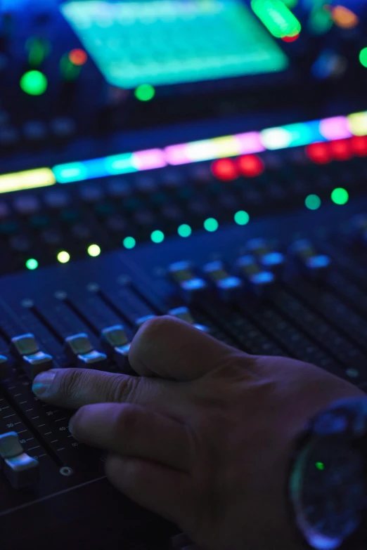 a person at an electronic sound mixing desk