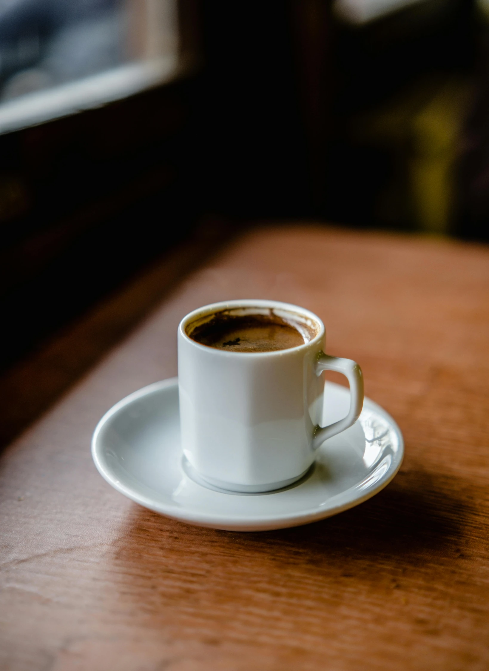 a cup with coffee sitting on top of a saucer