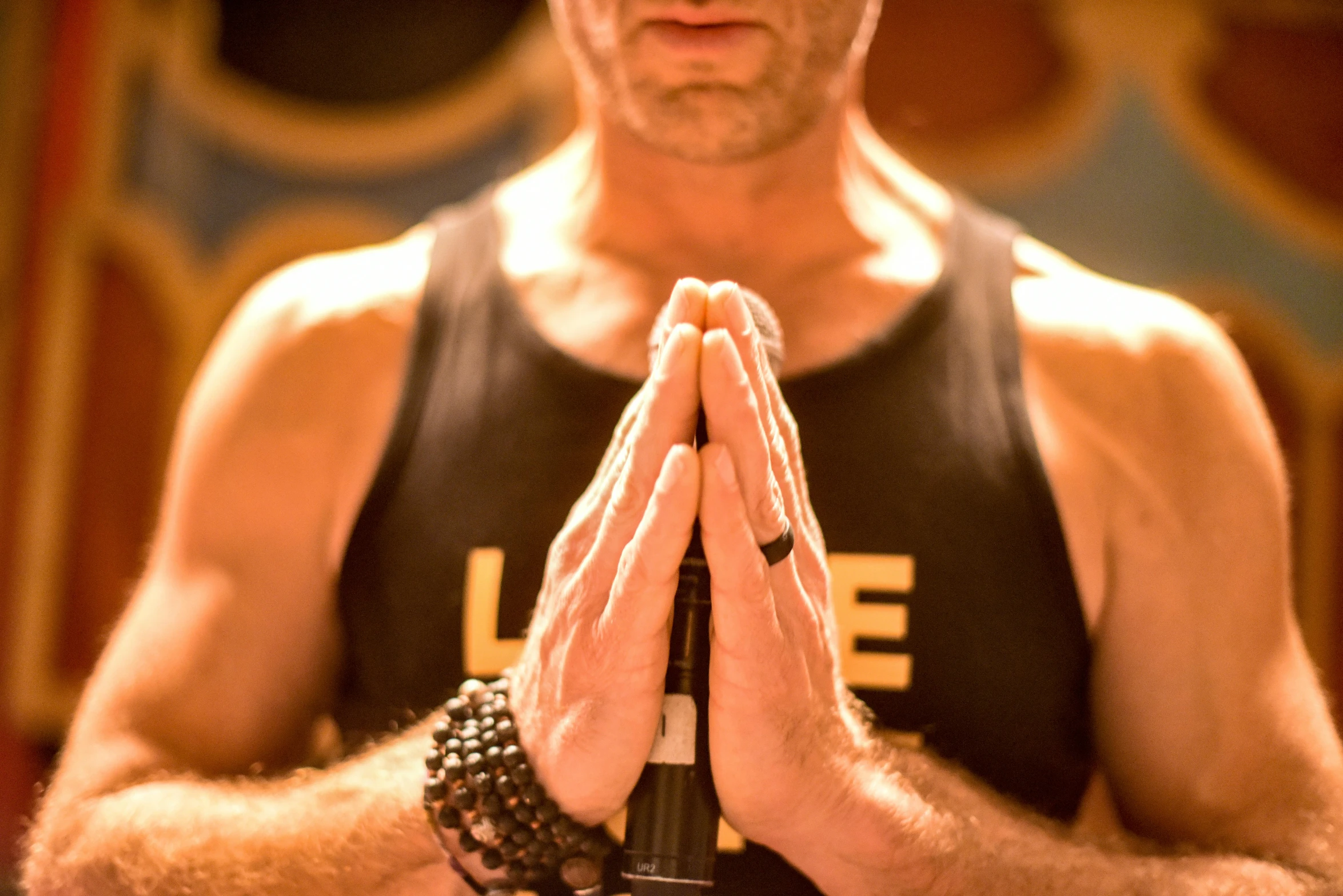 a man with his hands folded while sitting down