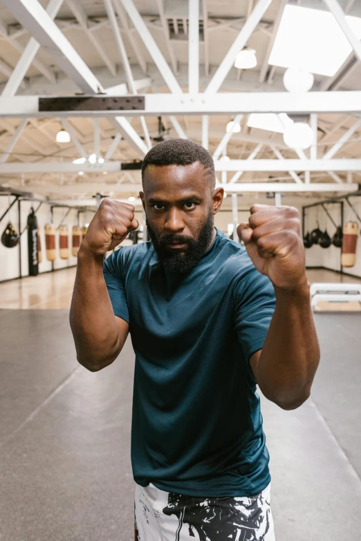 a man with the arms extended in his gym